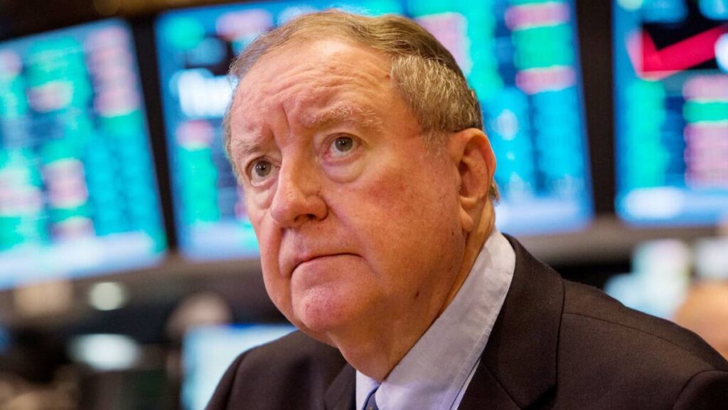 Art Cashin standing on the NYSE trading floor, symbolizing his financial legacy and accumulated wealth through Wall Street operations, media presence, and long-term investments.