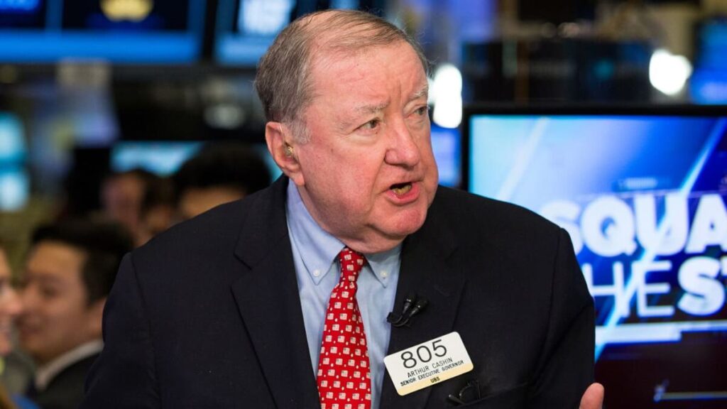 Art Cashin on the New York Stock Exchange floor, wearing his signature Irish sweater, overseeing trading operations as UBS Director of Floor Operations.