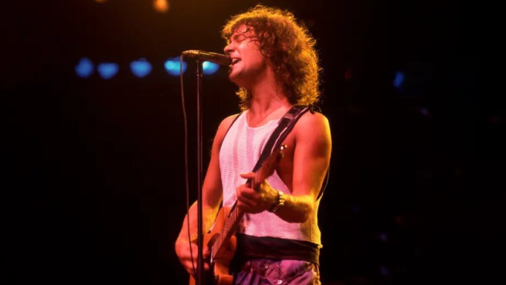 Billy Squier on stage with guitar during a concert in the 1980s