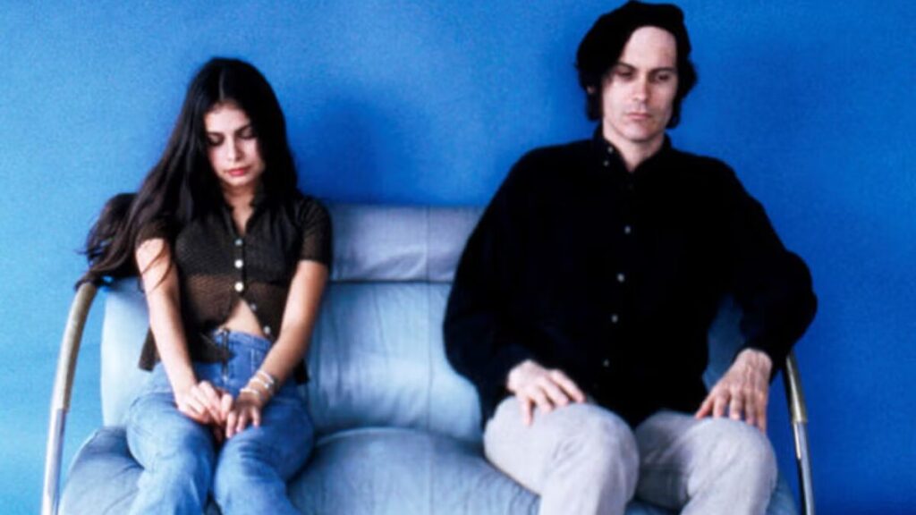 Hope Sandoval and David Roback sitting together in a relaxed, candid moment.