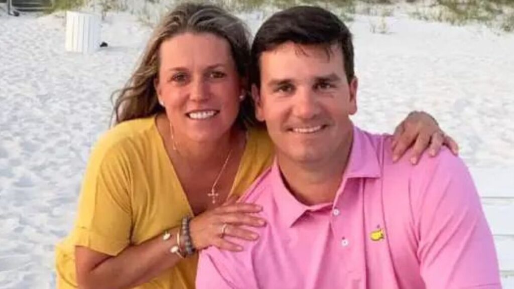 Jake Delhomme and his wife Keri Melancon smiling together on a beach, enjoying a sunny day.