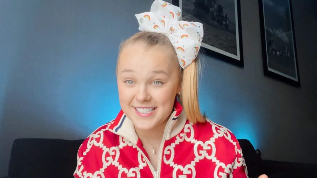 JoJo Siwa merchandise display including bows and toys, representing her licensing and retail income