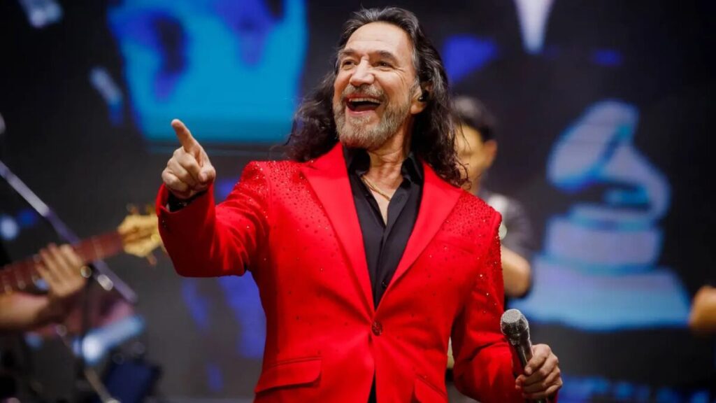Marco Antonio Solís at a concert, a major source of his earnings through tours, music sales, and endorsements.