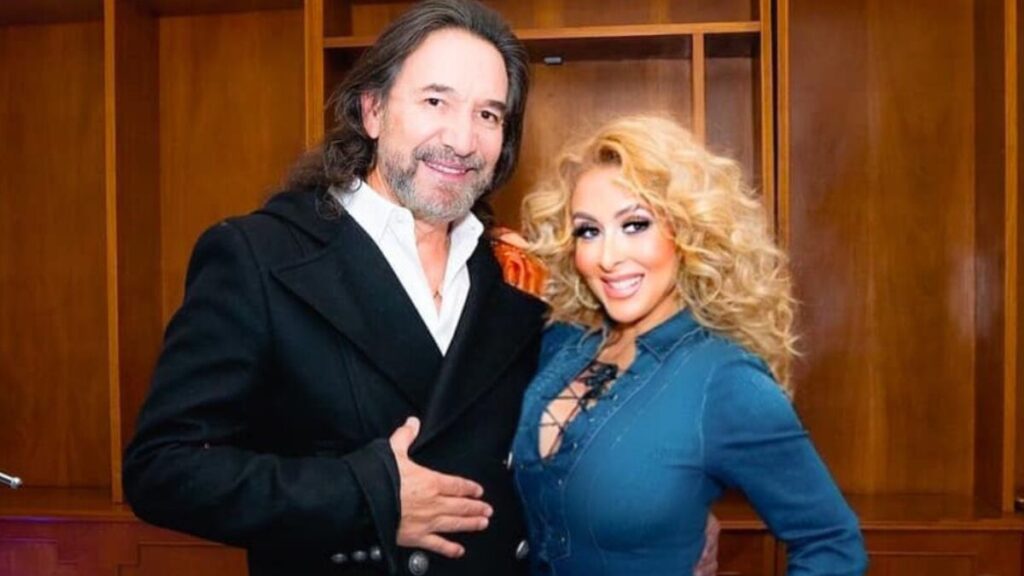 Marco Antonio Solís and Cristy Solís smiling together at a public event, showcasing their close relationship and family bond.