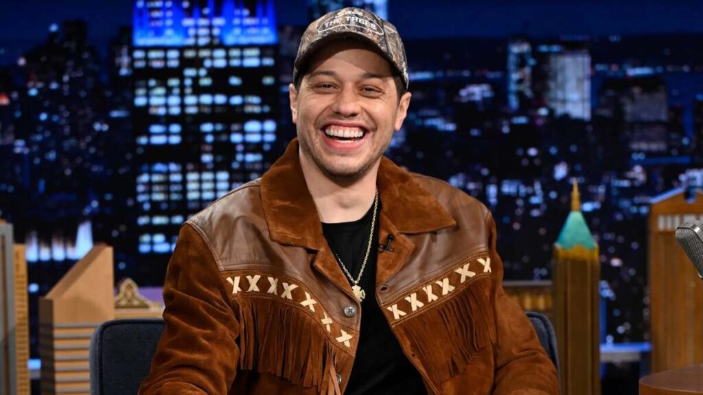 Pete Davidson performing stand-up comedy and starring in films, showcasing how he earns his income through entertainment and endorsements.