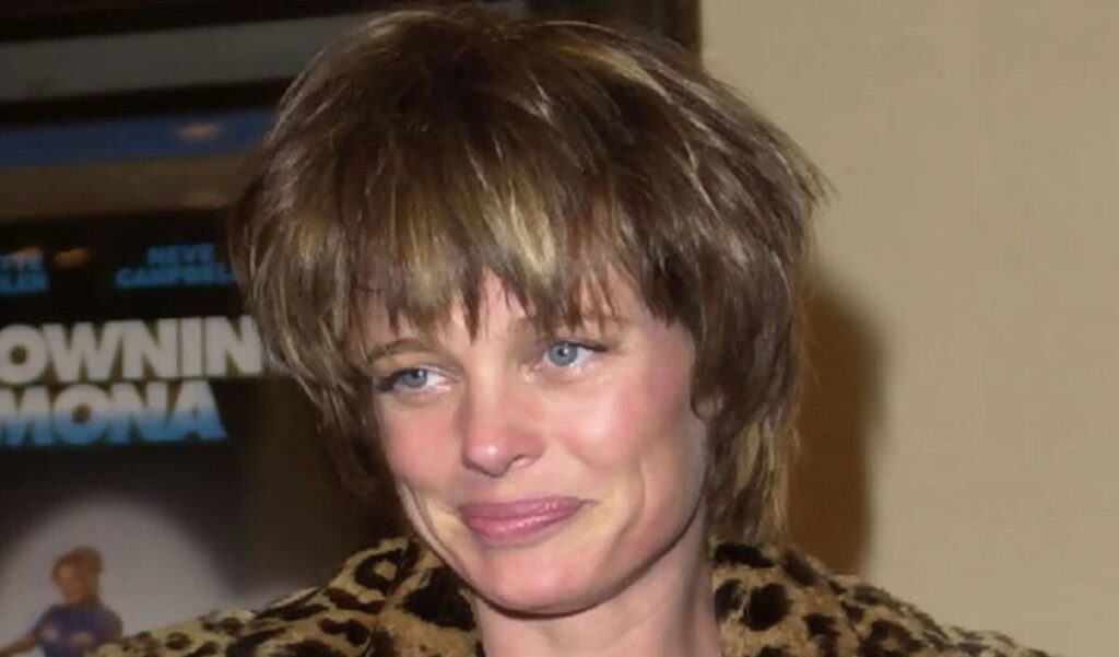 Rebecca Broussard on a film set in the 1990s, wearing a classic Hollywood outfit — known for roles in Die Hard, The Two Jakes, and Mars Attacks.
