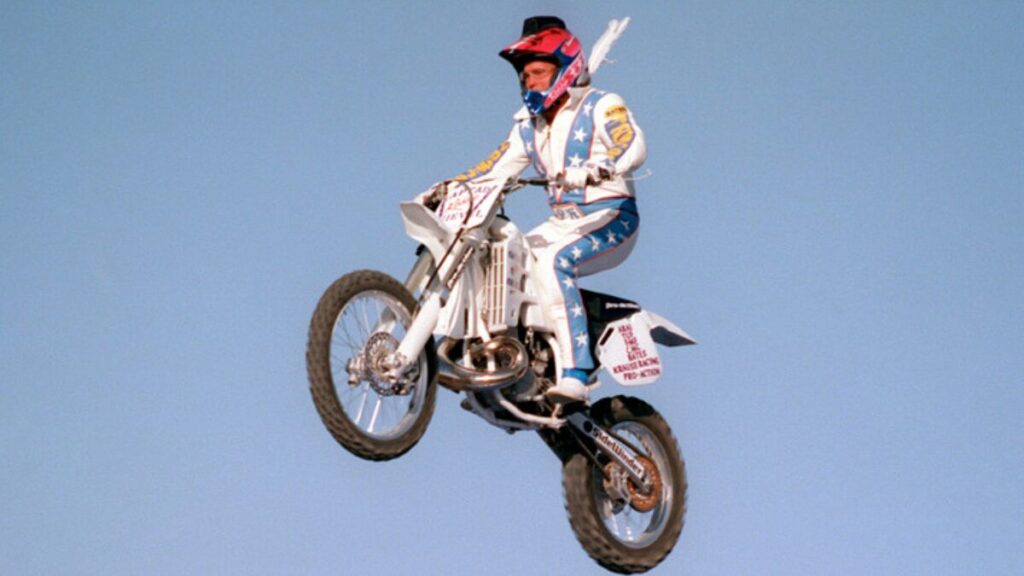 Robbie Knievel performing a high-flying motorcycle stunt during a live event
