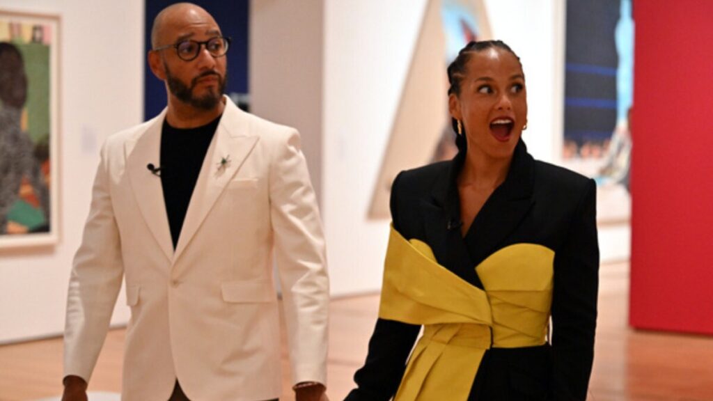 Alicia Keys and Swizz Beatz viewing contemporary artwork at an art exhibition, surrounded by vibrant paintings and sculptures.