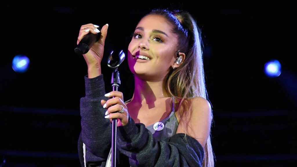 Ariana Grande performing on stage during her Sweetener World Tour, showcasing her rise as a global pop icon.