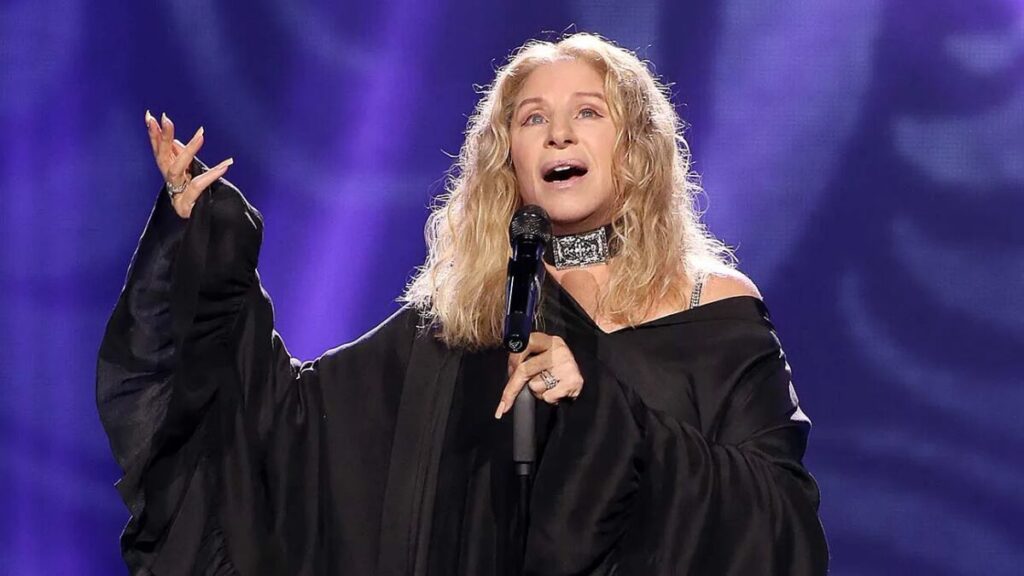 Barbra Streisand performing on stage during a concert, highlighting her legendary music and film career.