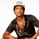 Bruno Mars posing in a stylish outfit for a promotional shoot
