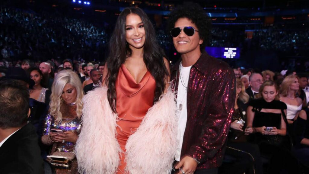 Bruno Mars and Jessica Caban posing at a Hollywood premiere.
