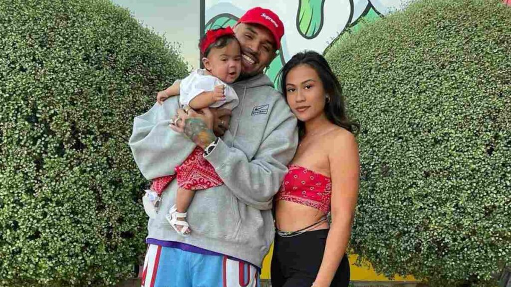 Chris Brown and Diamond Brown smiling with their daughter during a family outing.