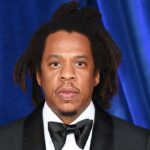Jay-Z wearing a suit at a red carpet event