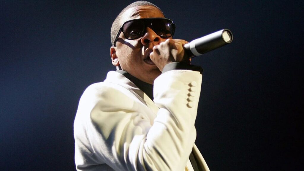 Jay-Z performing live during a major concert, representing his successful music career