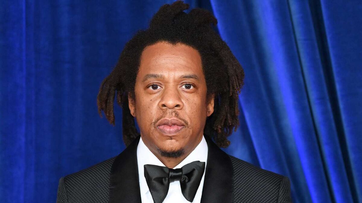 Jay-Z wearing a suit at a red carpet event