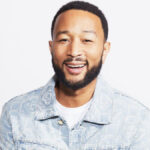 John Legend posing for a promotional photo in 2025