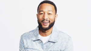 John Legend posing for a promotional photo in 2025