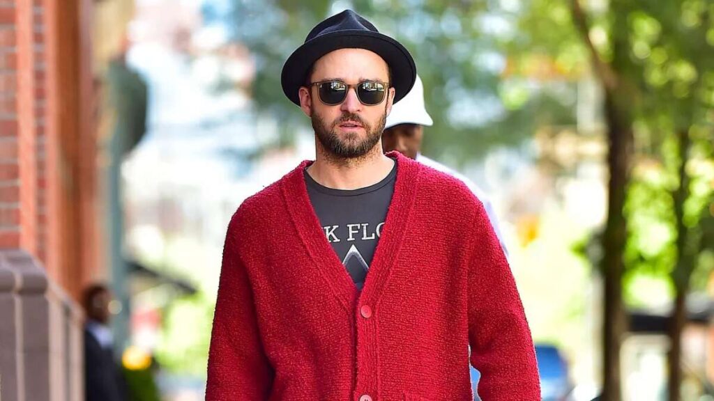Justin Timberlake walking on a city street in casual fashion, looking relaxed and stylish.