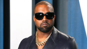 Close-up of Kanye West at a fashion event, looking serious and stylish