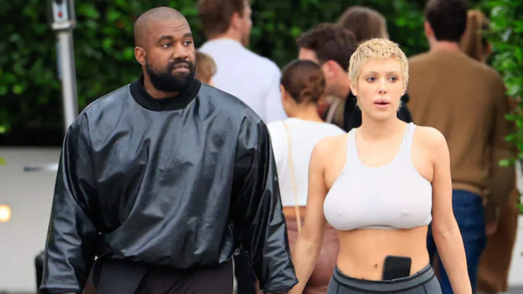 Kanye West and Bianca Censori walking together on the street in casual fashion attire