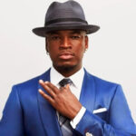 Ne-Yo at the Grammy Awards red carpet, dressed in formalwear and posing for photos.