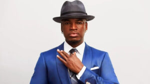 Ne-Yo at the Grammy Awards red carpet, dressed in formalwear and posing for photos.