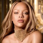 Rihanna smiling in a promotional shoot for Fenty Beauty