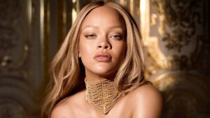 Rihanna smiling in a promotional shoot for Fenty Beauty
