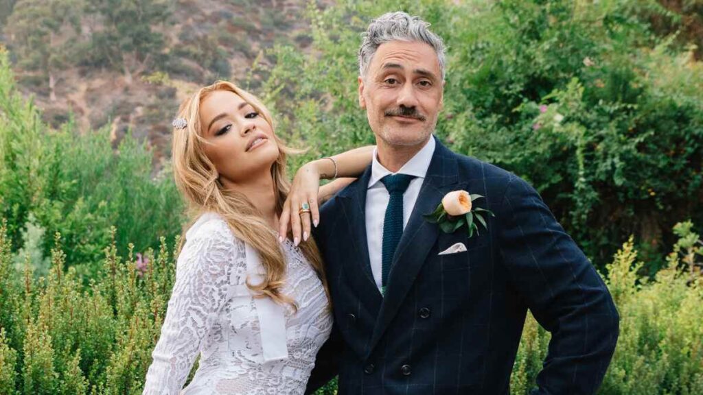 Rita Ora and Taika Waititi smiling together at a public event