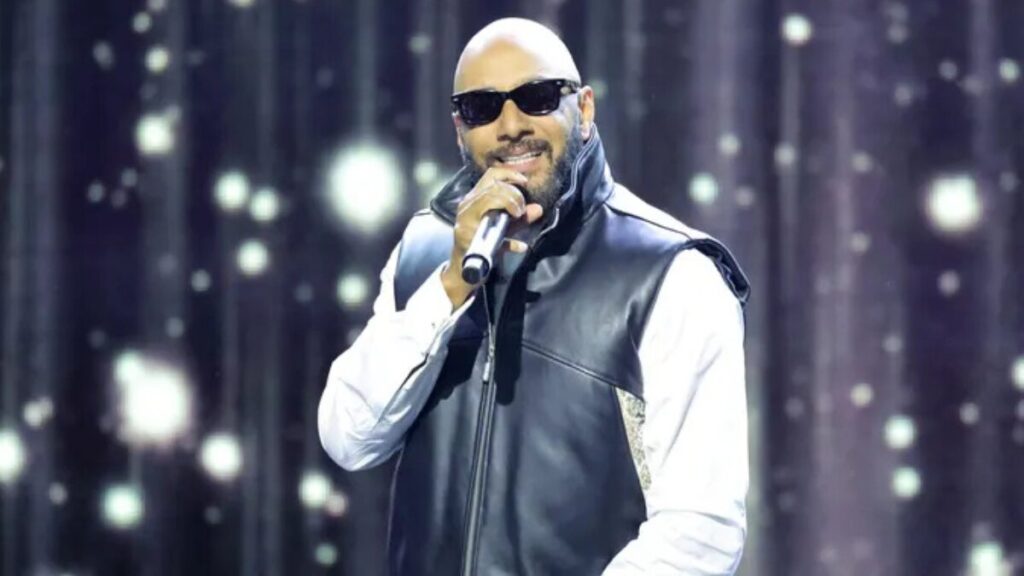 Swizz Beatz performing on stage during a music event, representing his career as a Grammy-winning producer and entrepreneur.