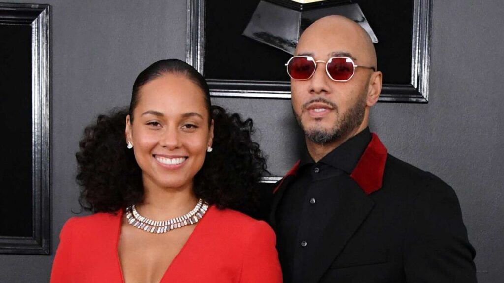 Swizz Beatz and Alicia Keys posing together at a red carpet event
