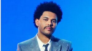 The Weeknd posing in designer fashion, reflecting his multimillion-dollar brand