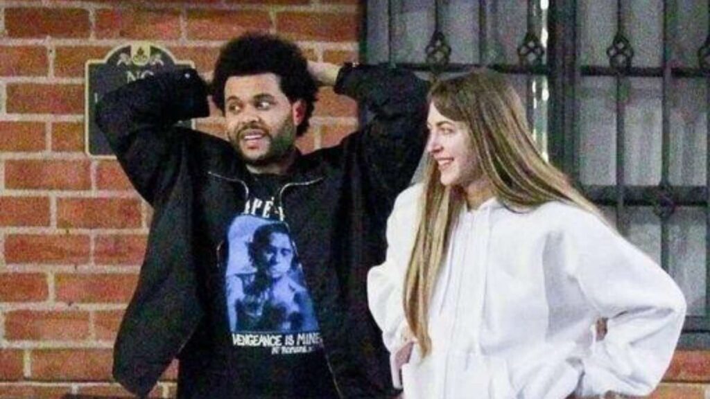 The Weeknd and Simi Khadra together on a city street, sparking dating rumors in early 2022.