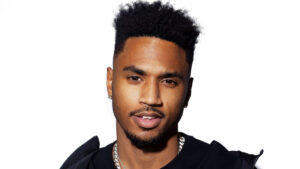 Trey Songz striking a pose in a studio with moody lighting and designer outfit