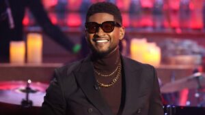 Usher performing on stage during Las Vegas residency with spotlight