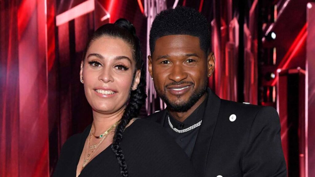 Usher and Jenn Goicoechea posing together at a red carpet event in stylish evening attire, showcasing their relationship and public presence.