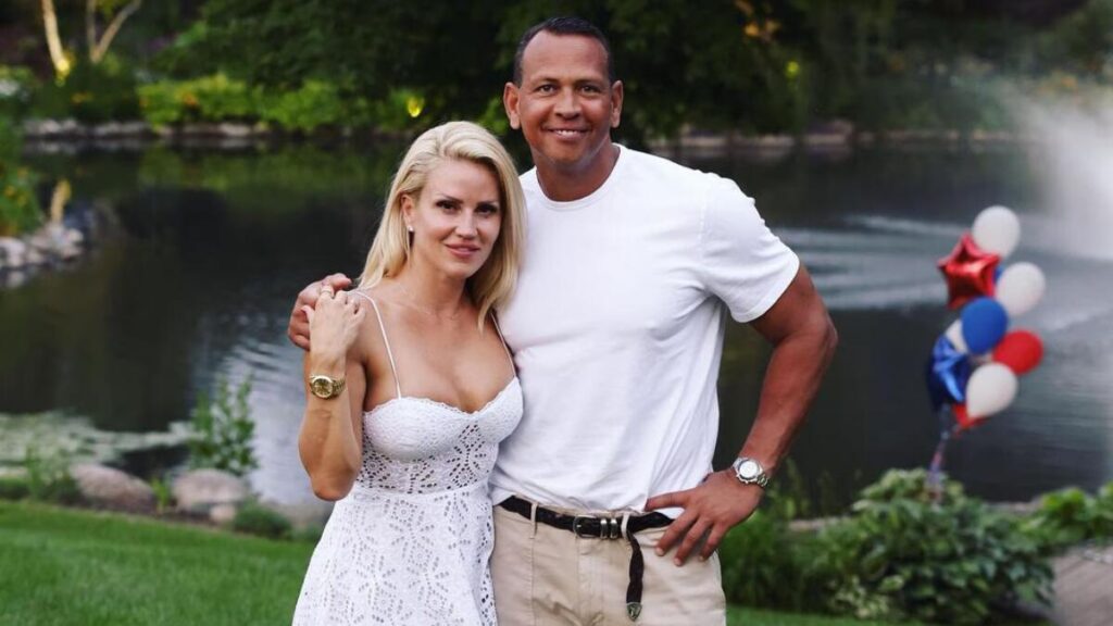 Alex Rodriguez and girlfriend Jaclyn Cordeiro smiling together at a public event, showcasing their shared passion for fitness and wellness.