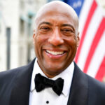 Byron Allen smiling at media event, 2025