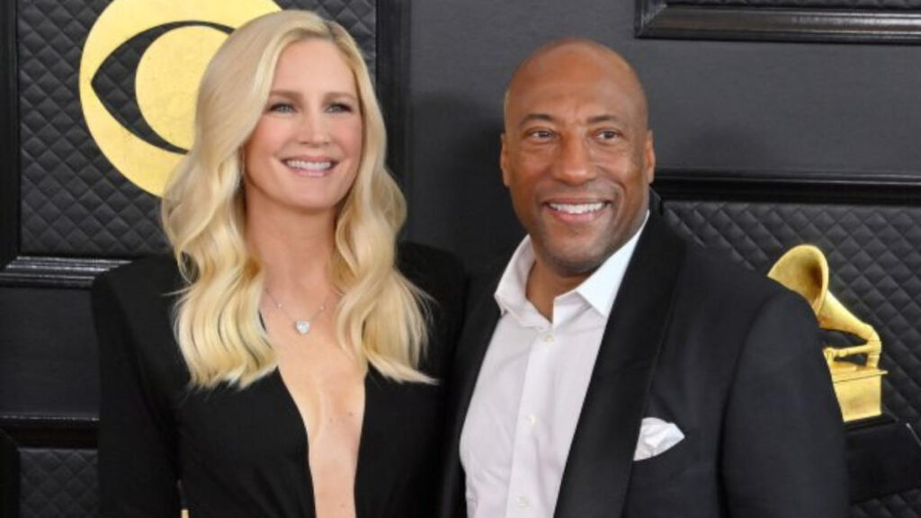 Byron Allen and his wife Jennifer Lucas pose together on the red carpet at the Grammy Awards, dressed in formal evening wear.