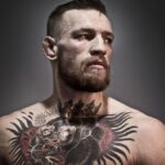 Conor McGregor is posing confidently during a professional photo shoot, showcasing his luxury fashion style and bold persona.