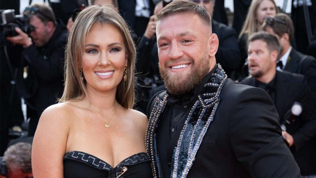 Conor McGregor and fiancée Dee Devlin posing at a red carpet event.