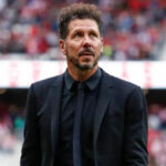 Diego Simeone in a black suit during a football match