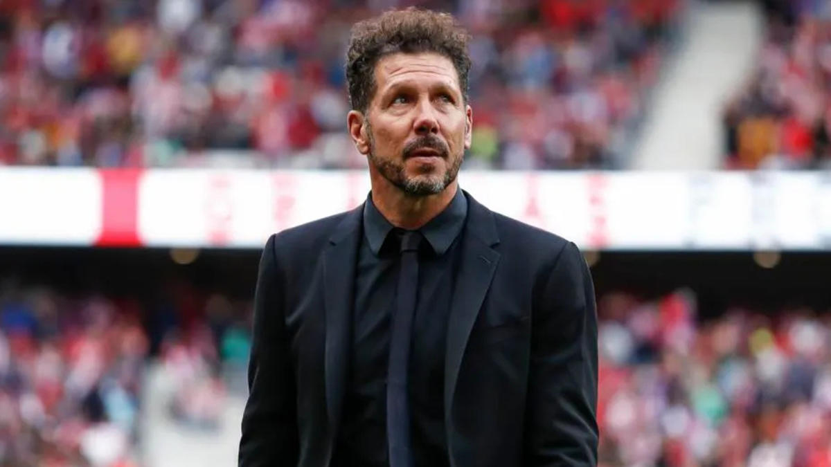 Diego Simeone in a black suit during a football match