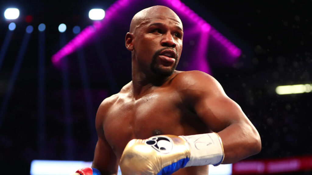Floyd Mayweather Jr. landing a punch during a title fight in the boxing ring