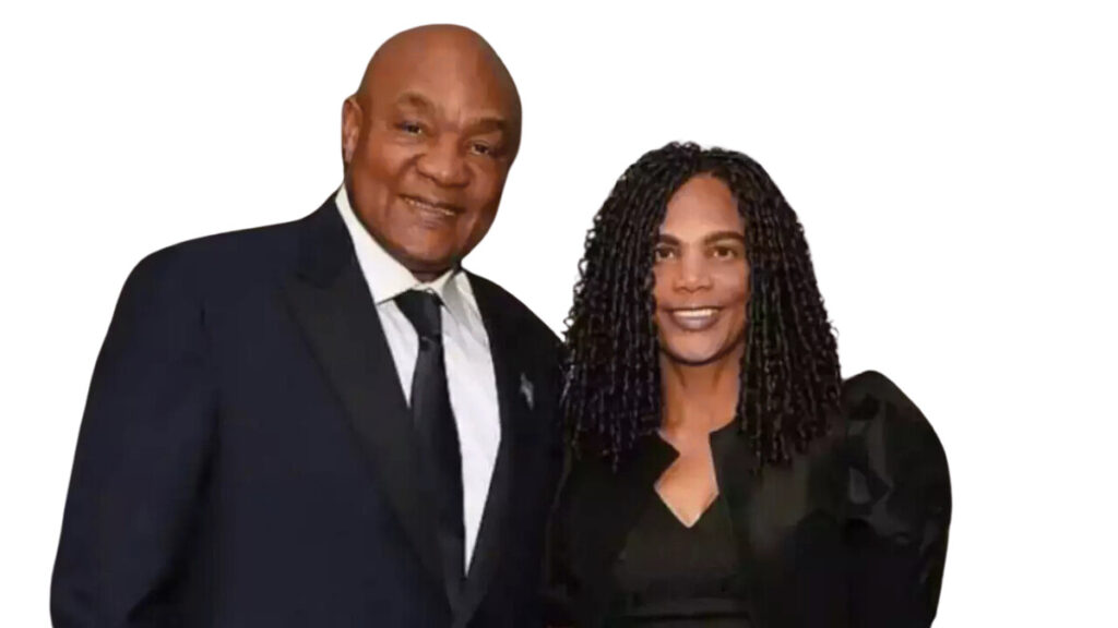 George Foreman posing with his wife Mary Joan Martelly in formal attire