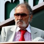 Ion Țiriac, Romanian billionaire and former tennis player, wearing a suit and glasses