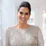 Jami Gertz posing in a professional brand shoot, wearing elegant attire, representing her role as a successful actress and billionaire businesswoman.