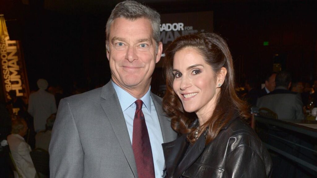 Actress Jami Gertz with husband Tony Ressler at a red carpet event, known for her acting and billion-dollar net worth.