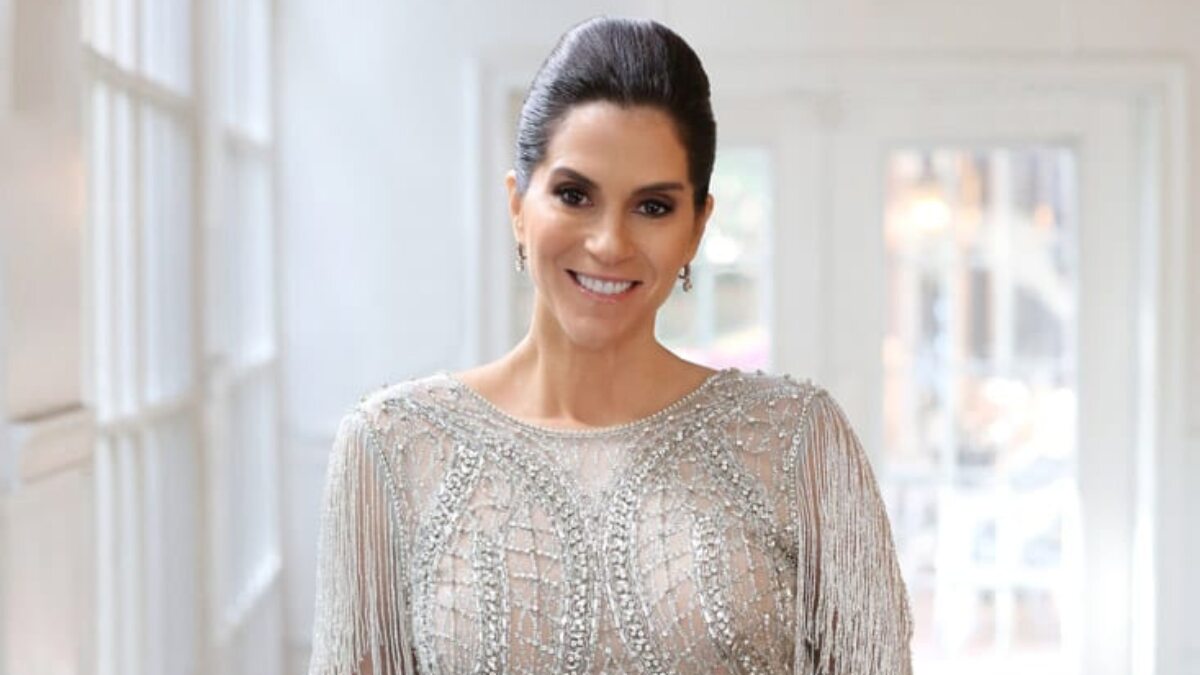 Jami Gertz posing in a professional brand shoot, wearing elegant attire, representing her role as a successful actress and billionaire businesswoman.